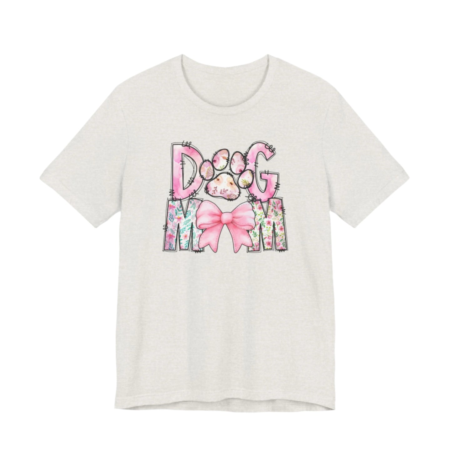 The Paws & Petals Dog Mom T-Shirt by Banks + Cove is a charming tribute for pet lovers, showcasing DOG MOM in vibrant letters with the O as a paw print and a pink bow with watercolor florals on the M, all on a light-colored tee.