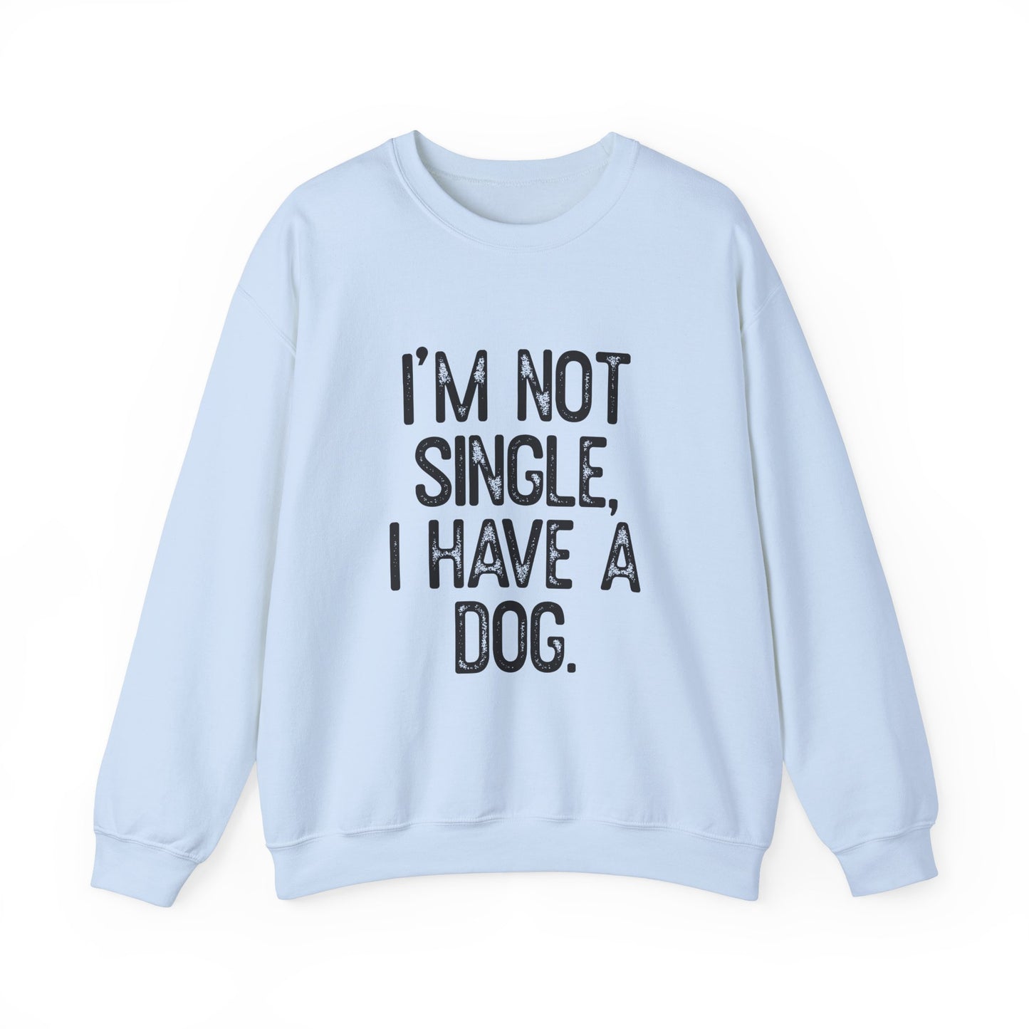 The Printify Funny Dog Lover Crewneck Sweatshirt features bold black lettering, Im Not Single, I Have A Dog, on a light blue unisex design. Cozy and stylish, its perfect for dog lovers and stands out against a plain white background.