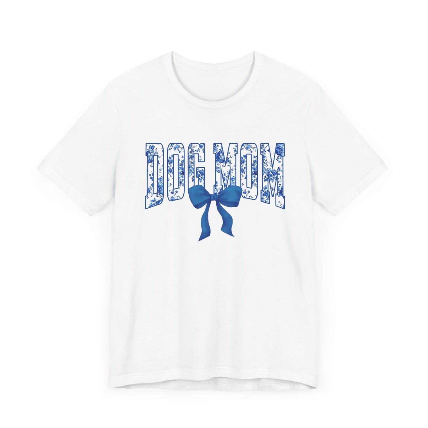 The Banks + Cove Dog Mom Blue T-Shirt showcases DOG MOM in bold blue floral print, embellished with a cute blue bow illustration.