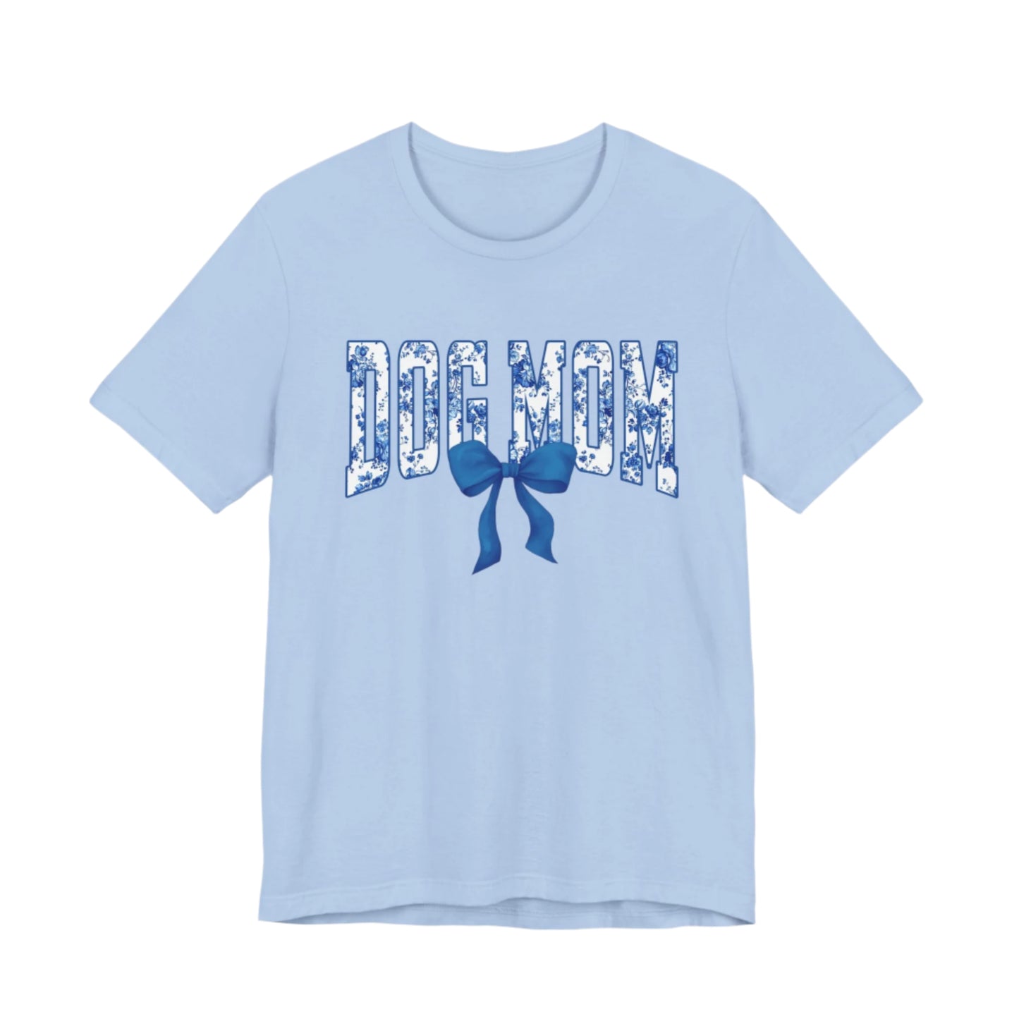 The Banks + Cove Dog Mom Blue T-Shirt is a light blue varsity tee featuring DOG MOM in floral print letters with a charming blue bow below.