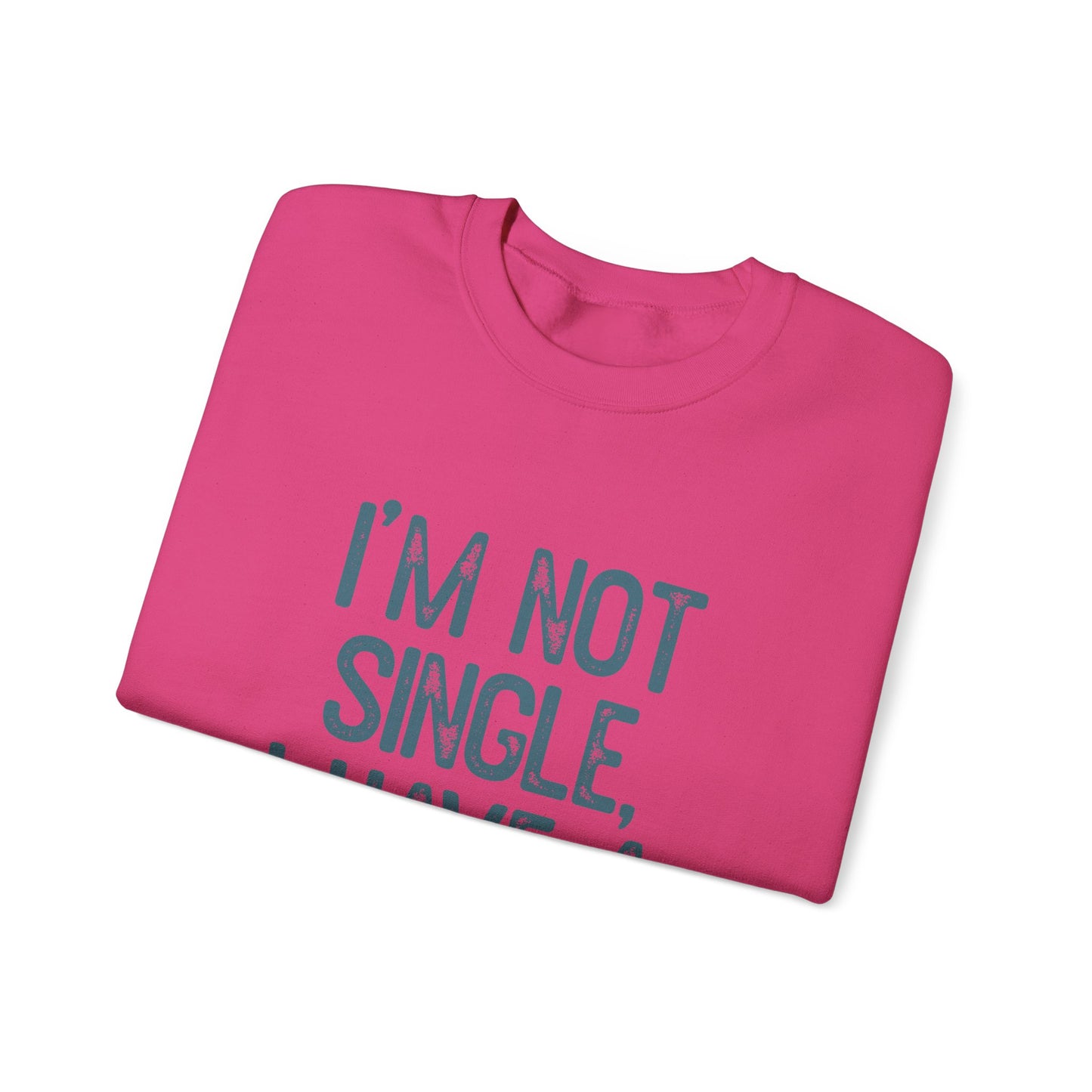 A folded pink I’m Not Single crewneck from Banks + Cove lies on a white background, perfect as a pet owner gift, blending playful style and heartfelt sentiment.
