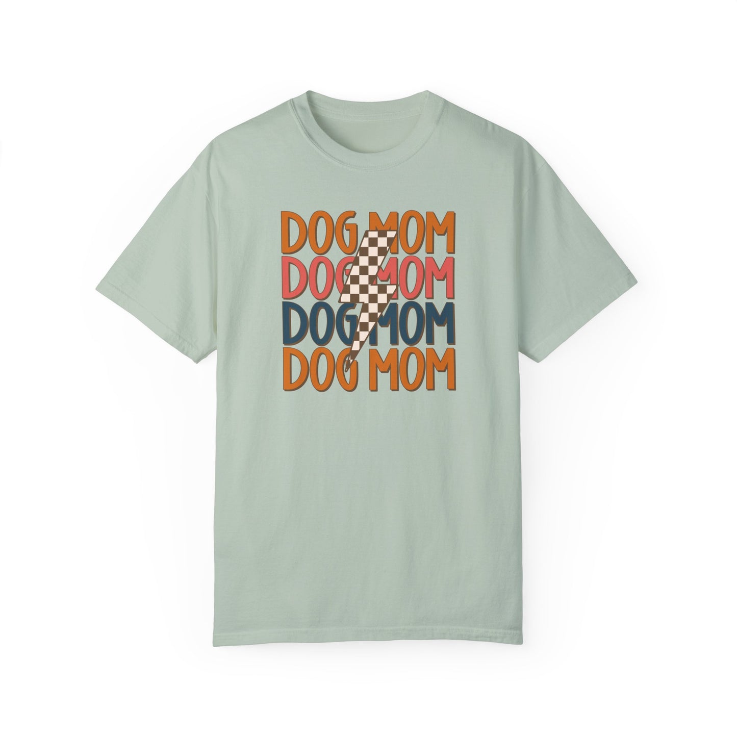 The Checkered Vibes Dog Mom Tee by Banks + Cove is a light green, retro-style tee featuring DOG MOM printed in orange, red, and blue with an overlay of a checkered lightning bolt. Perfect for trendy moms who want to flaunt their Dog Mom Energy.