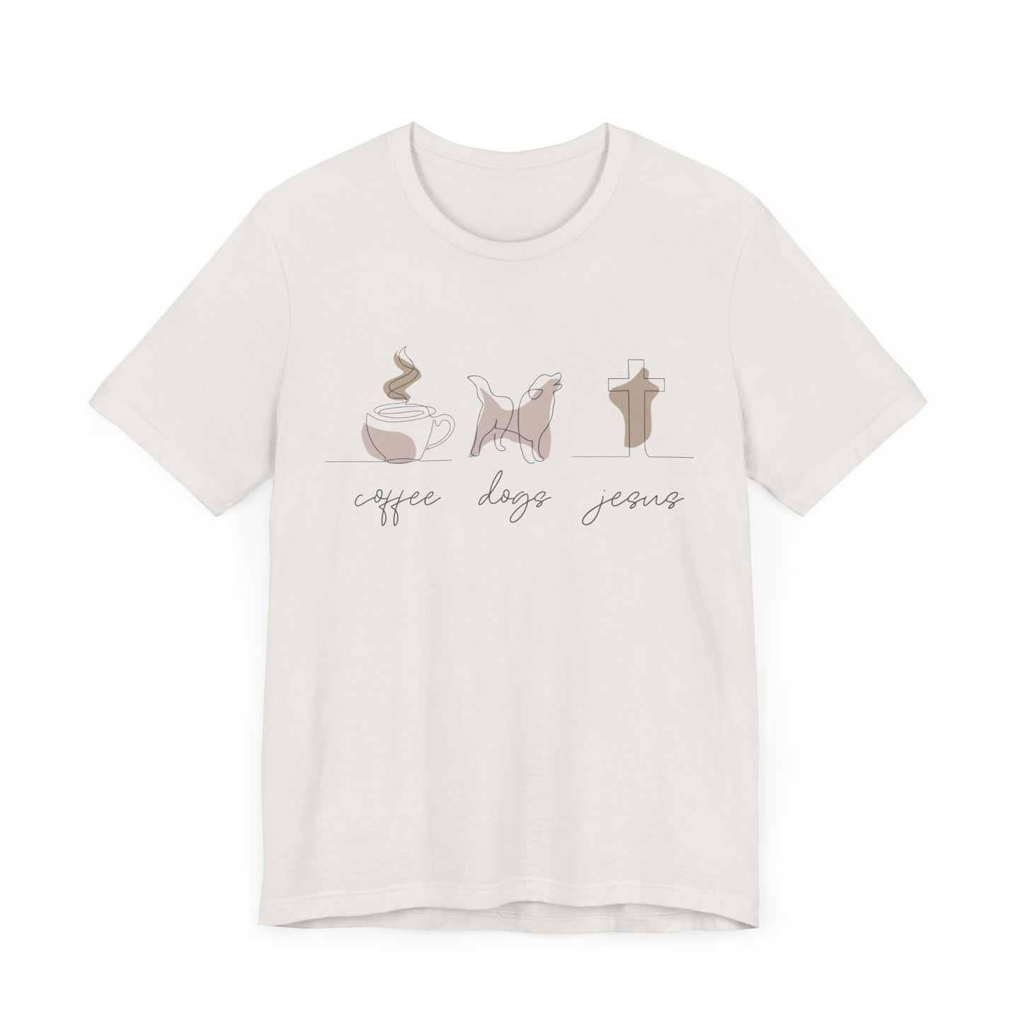 The Coffee Dogs Jesus Tee by Printify is a unisex short sleeve T-shirt made from soft Airlume cotton, featuring illustrations of a steaming coffee cup, a dog, and a cross. Below each image are the words coffee, dogs, and faith in cursive.