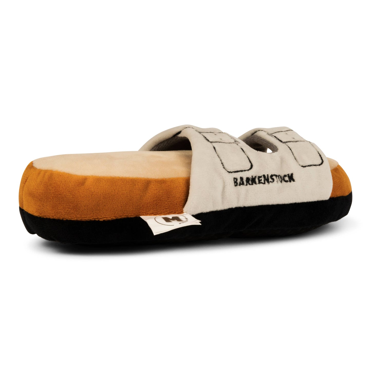 The Muttzie Barkenstock Sandal Toy is a plush, shoe-shaped toy with a beige/brown color scheme, black sole, and adjustable straps. Barksnstuck is embroidered on the side, mimicking a popular sandal brand. It includes a double squeaker for extra fun.