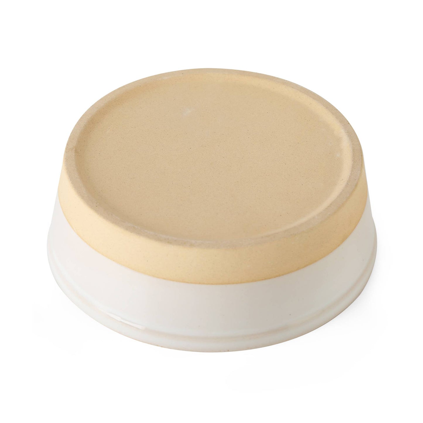 The Nordic Cream Pet Bowl by Park Life Designs is a small, round ceramic dish with a beige top and white bottom, set against a white background. Its simple yet elegant design evokes the stylish look of Nordic pet bowls with a refined clay base.