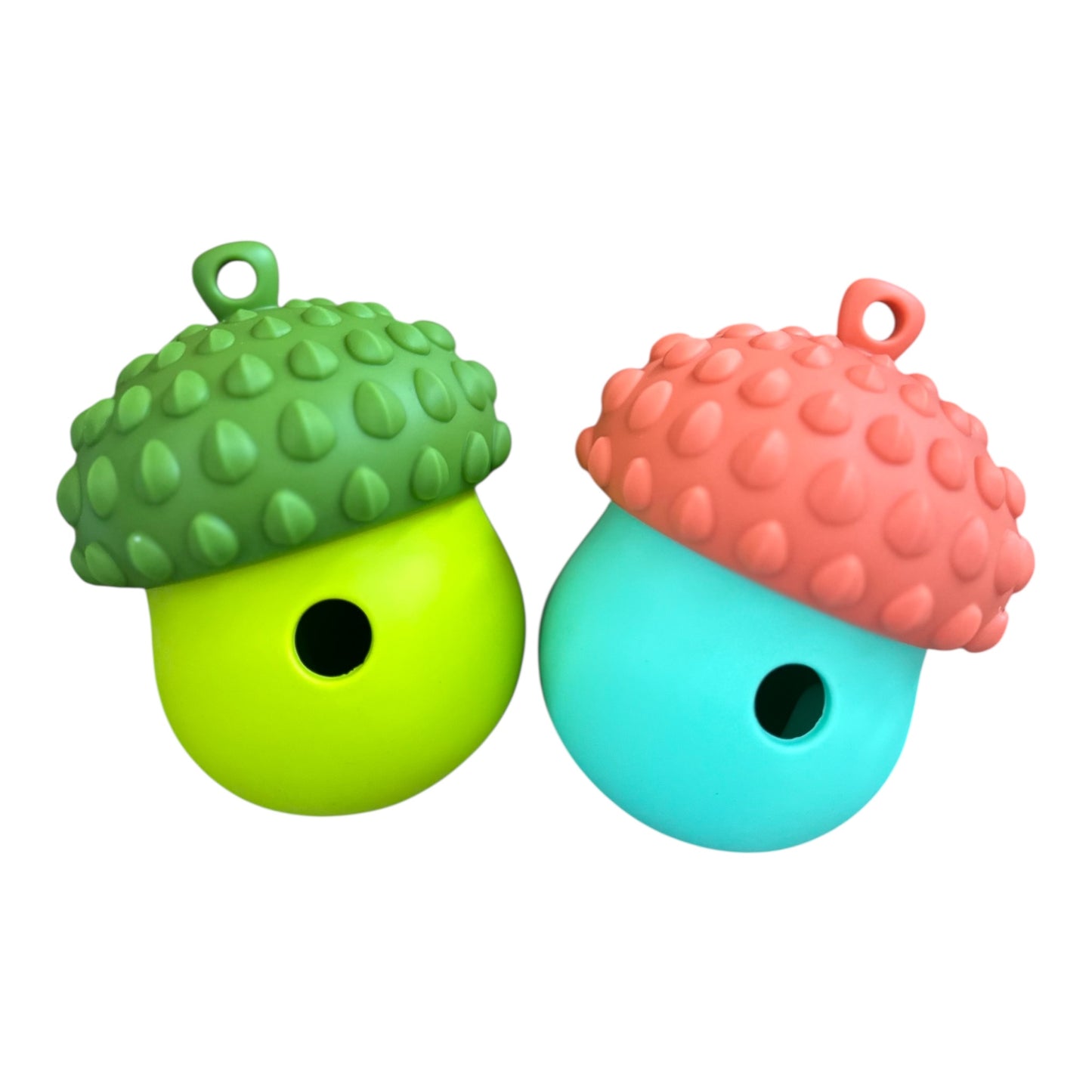 The Banks + Cove Barkorn Treat Holding Dog Enrichment Toy set includes two acorn-shaped, food-grade silicone treat dispensers with loops, in green/dark cap and blue/pink cap, designed to mentally stimulate pets.
