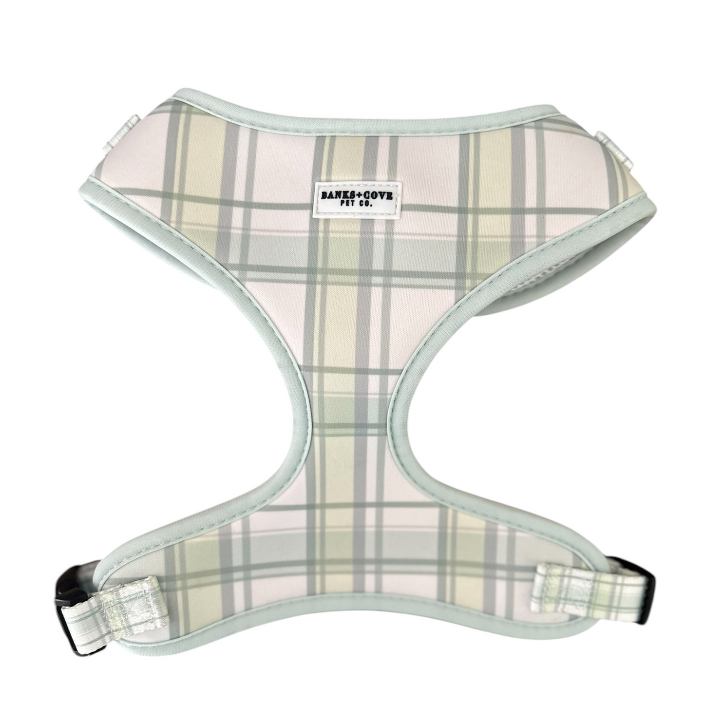 The Plaid About You dog harness from Banks + Cove boasts a green plaid design with pastel shades of beige, gray, and white. It features light blue trim, an adjustable fit for comfort and style, and a brand label adding flair to your pets fashionable look.