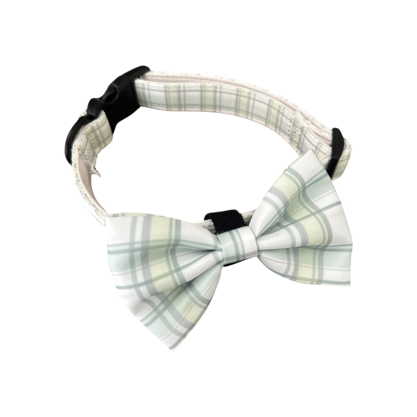 The Plaid About You - Bow from Banks + Cove is a stylish dog collar with a light green and white plaid bowtie. Its adjustable design and plastic buckle make it both elegant and functional, the ideal accessory for dogs wanting to impress.