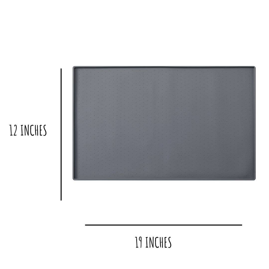 The Silicone Mess Free Pet Placemat by Park Life Designs is displayed, featuring a non-stick surface similar to your rectangular baking trays dark gray hue, sized at 12x19 inches. Both ensure stability and ease during your kitchen tasks.