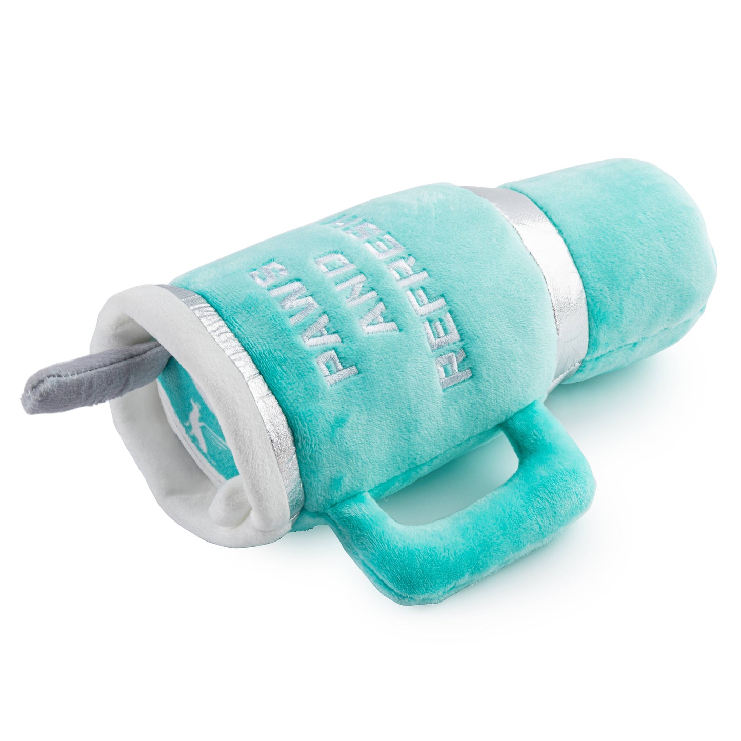 The Haute Diggity Dogs Snuggly Cup - Teal is a plush dog toy shaped like a cup with PAWS AND REFRESH in white. It has a handle and a gray plush tongue at the opening, resembling a playful squeaky tumbler.
