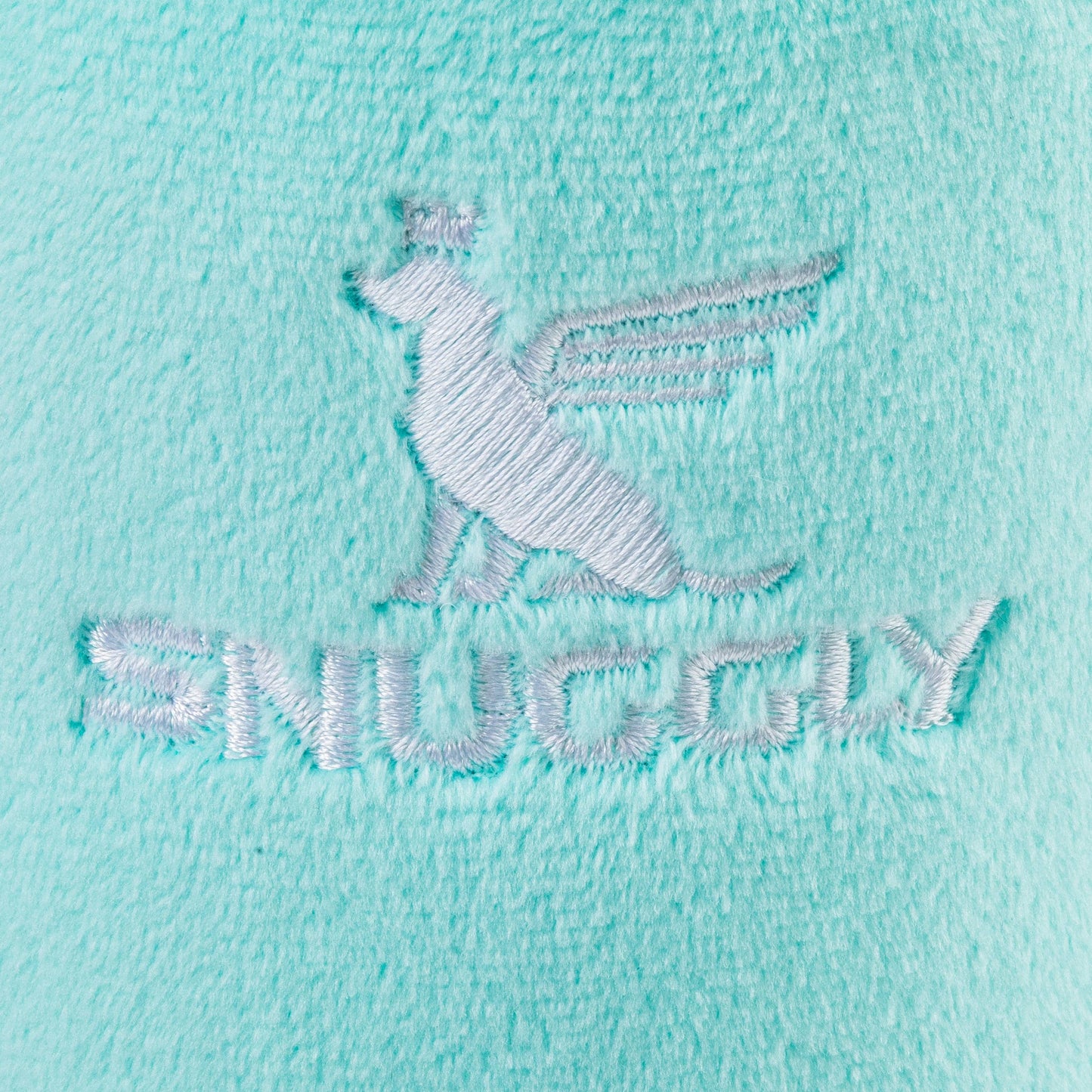 The Snuggly Cup - Teal by Haute Diggity Dog features a light turquoise fabric with an embroidered winged dog logo and SNUGGY in white thread, offering plush comfort and charm to your collection.