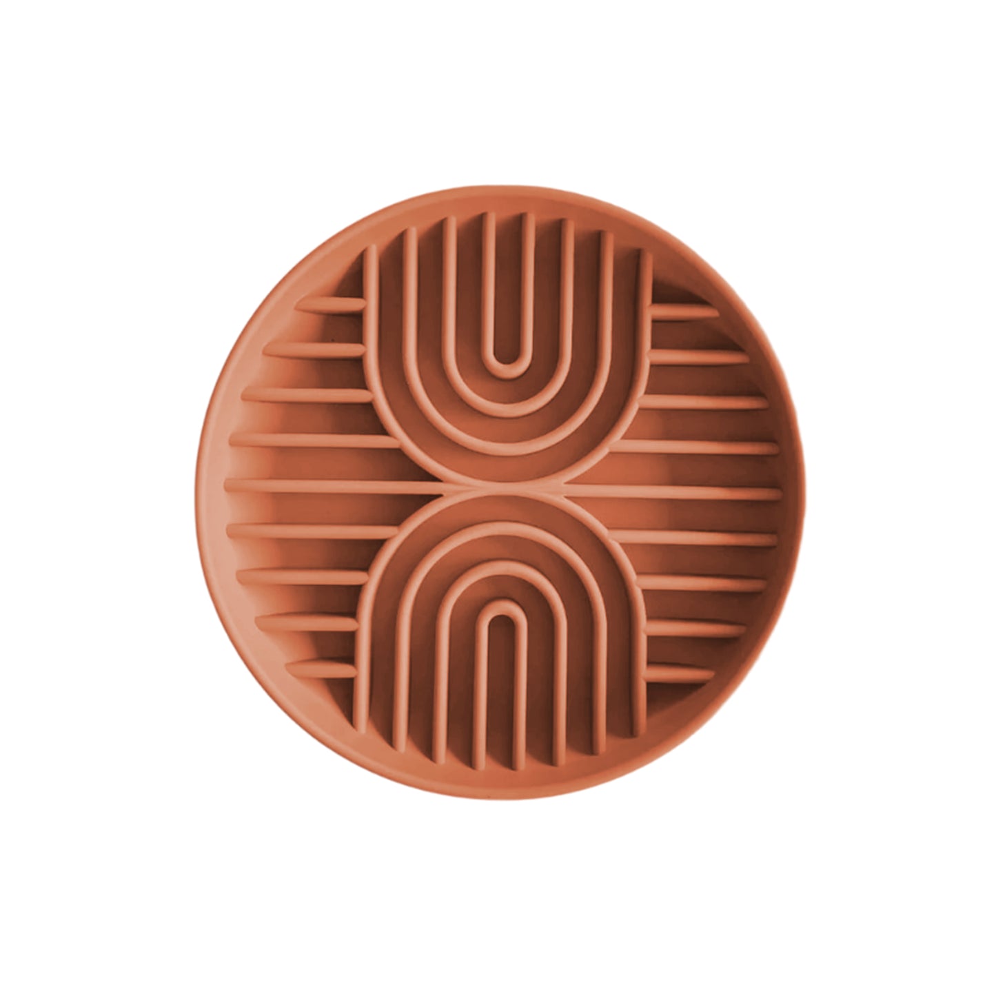 A terracotta-colored clay coaster with an abstract geometric pattern of raised arches and lines enhances the look of the Double Rainbow Slow Feeder by Banks + Cove.