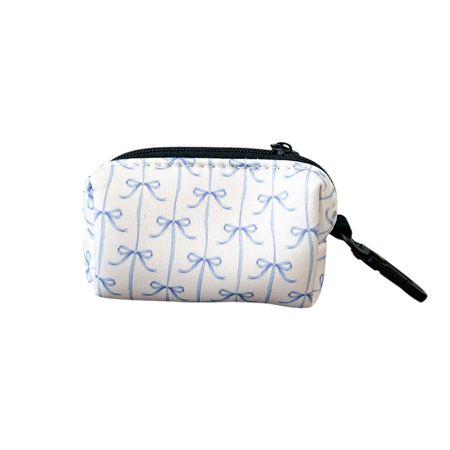The Banks + Cove Distinguished Gentlepup Waste Bag Holder is a small, durable white pouch with a blue bow pattern, featuring a black zipper and a side keychain attachment for easy access during walks.