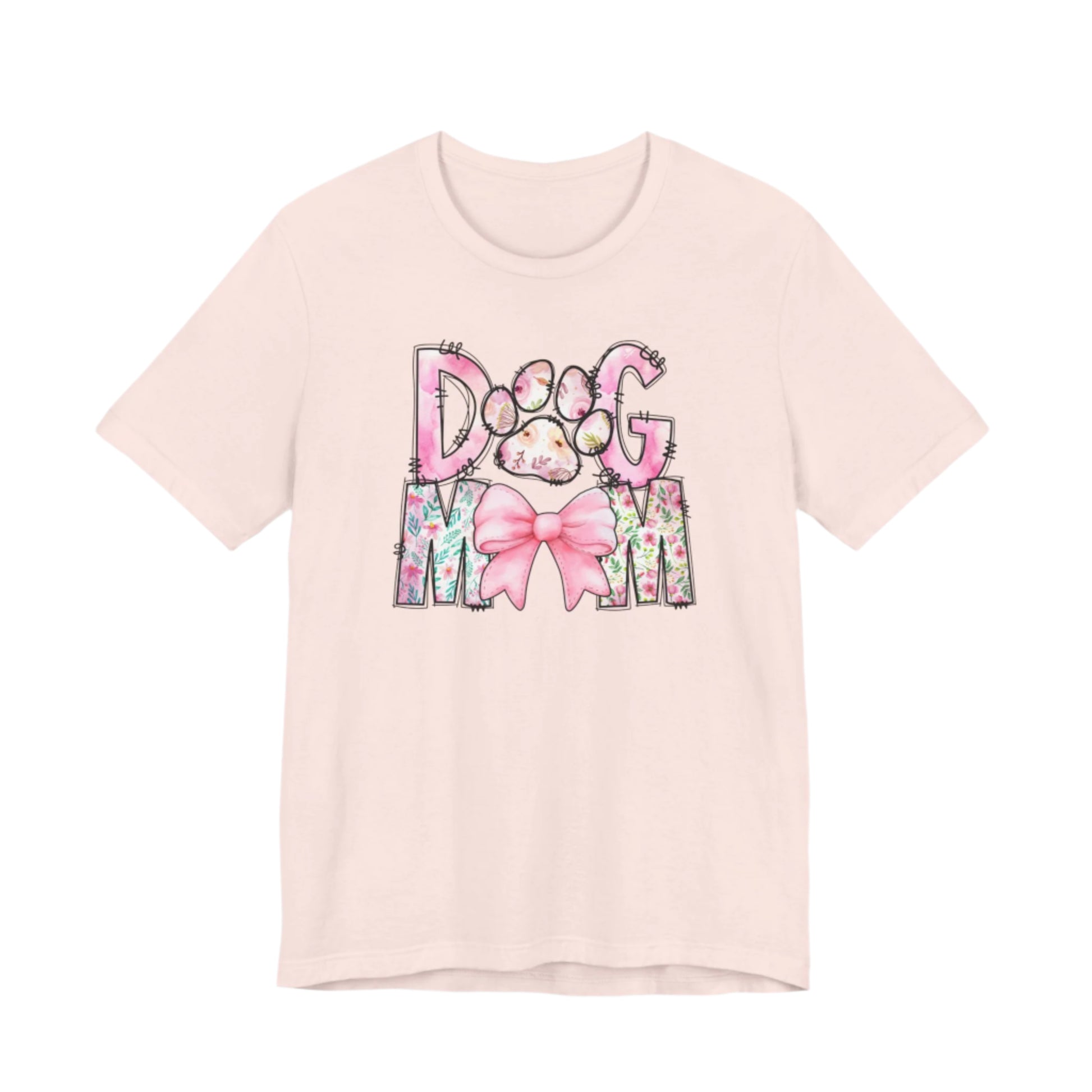 Celebrate your love for dogs with the Banks + Cove Paws & Petals Dog Mom T-Shirt, featuring watercolor florals, a pink bow, and a charming Dog Mom design, complete with an adorable paw print.