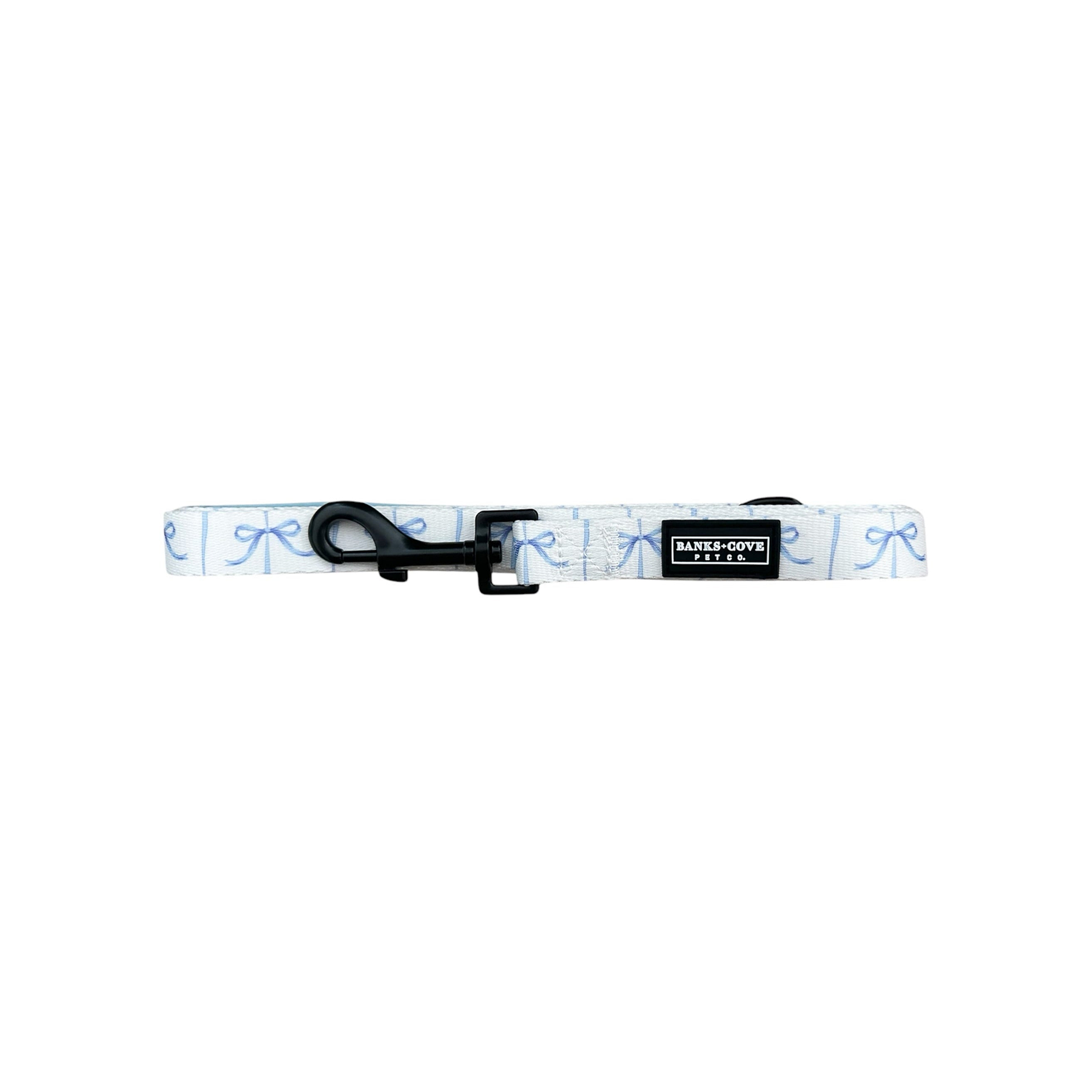 Displayed is the Distinguished Gentlepup Dog Collar by Banks + Cove, a stylish white collar with light blue bow patterns. It features a durable black buckle clasp and tag. Lying flat on a white background, it perfectly matches its leash.